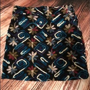 short skirt with hand-embroidered details.